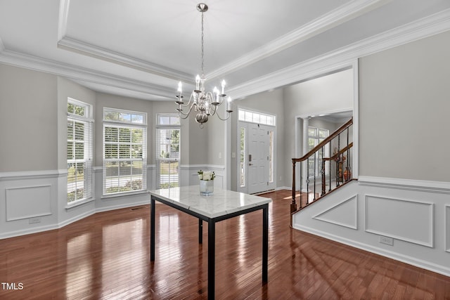 316 Hilliard Forest Dr, Cary, NC 27519 - unfurnished dining area with a chandelier, stairs, ornamental molding, dark wood-style floors, and wainscoting