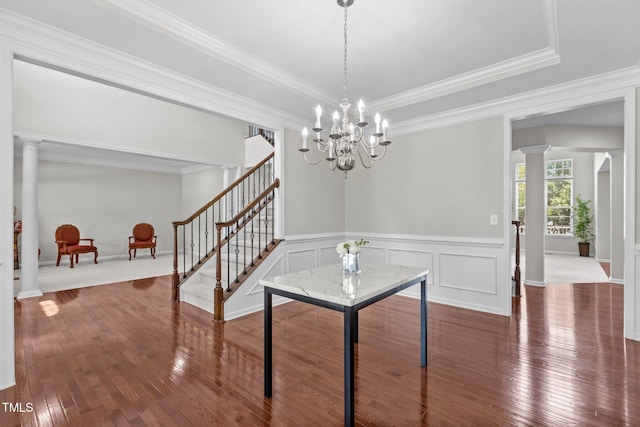 316 Hilliard Forest Dr, Cary, NC 27519 - unfurnished dining area with hardwood / wood-style floors, stairway, ornate columns, crown molding, and a wainscoted wall