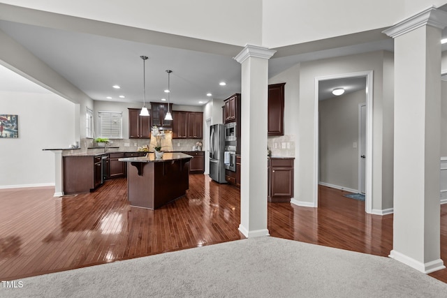 316 Hilliard Forest Dr, Cary, NC 27519 - kitchen with appliances with stainless steel finishes, decorative columns, dark wood-type flooring, wall chimney exhaust hood, and a kitchen island