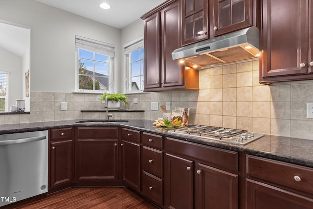 316 Hilliard Forest Dr, Cary, NC 27519 - kitchen featuring stainless steel appliances, under cabinet range hood, dark stone countertops, dark wood-style flooring, and decorative backsplash