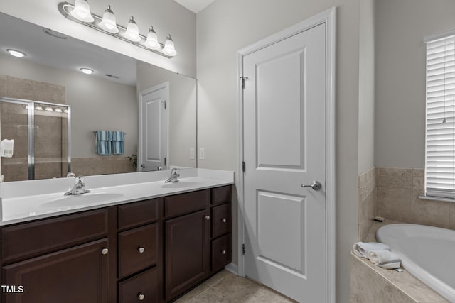 316 Hilliard Forest Dr, Cary, NC 27519 - bathroom with double vanity, a garden tub, a shower stall, and tile patterned flooring
