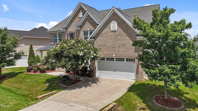 316 Hilliard Forest Dr, Cary, NC 27519 - view of front facade with driveway, brick siding, a front lawn, and roof with shingles