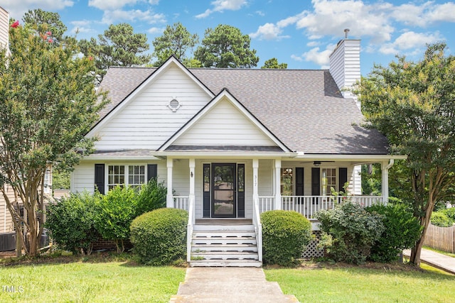 317 Yellow Poplar Ave, Wake Forest, NC 27587 - view of front of property with covered porch, a shingled roof, and a chimney