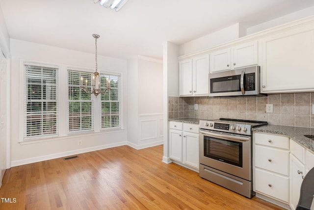 317 Yellow Poplar Ave, Wake Forest, NC 27587 - kitchen featuring stainless steel appliances, a chandelier, tasteful backsplash, and light stone counters