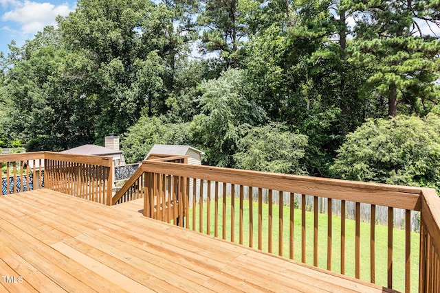 317 Yellow Poplar Ave, Wake Forest, NC 27587 - deck featuring a storage shed, a lawn, and view of wooded area