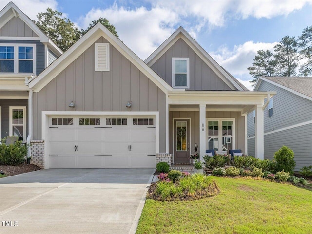 820 Whistable Ave, Wake Forest, NC 27587 - craftsman house with board and batten siding, driveway, a front lawn, covered porch, and an attached garage