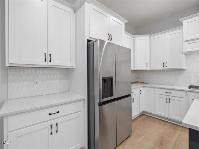 820 Whistable Ave, Wake Forest, NC 27587 - kitchen featuring stainless steel appliances, white cabinetry, decorative backsplash, and light wood-style floors