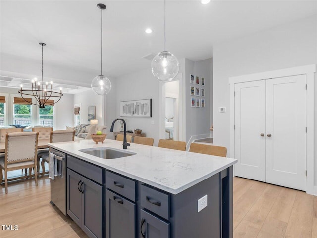 820 Whistable Ave, Wake Forest, NC 27587 - kitchen with open floor plan, dishwasher, a chandelier, light wood-style flooring, and hanging light fixtures
