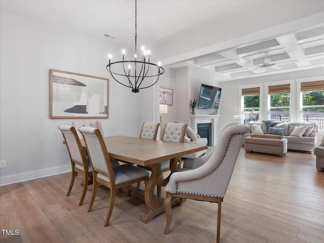 820 Whistable Ave, Wake Forest, NC 27587 - dining room featuring coffered ceiling, a chandelier, light wood-type flooring, a fireplace, and beamed ceiling