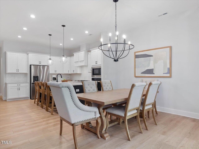820 Whistable Ave, Wake Forest, NC 27587 - dining space with a chandelier, light wood-style flooring, and recessed lighting