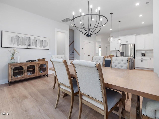 820 Whistable Ave, Wake Forest, NC 27587 - dining space featuring a chandelier, stairs, light wood-type flooring, and recessed lighting