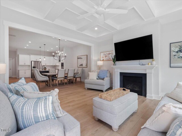 820 Whistable Ave, Wake Forest, NC 27587 - living area with recessed lighting, coffered ceiling, light wood-style floors, a ceiling fan, and a fireplace