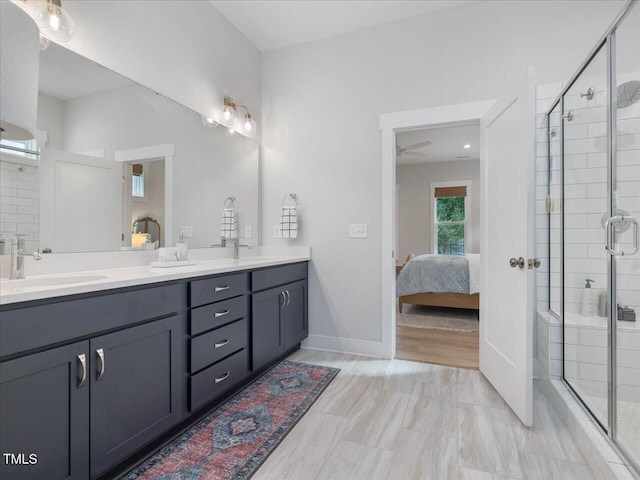 820 Whistable Ave, Wake Forest, NC 27587 - bathroom featuring double vanity, a shower stall, ensuite bathroom, and a ceiling fan