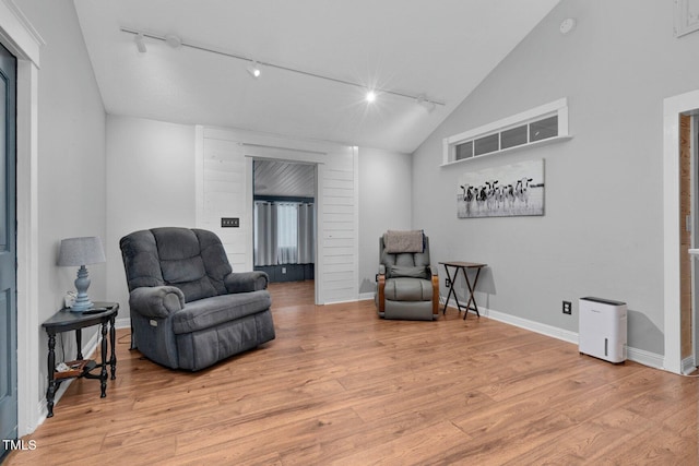 196 Red Wing Dr, Louisburg, NC 27549 - sitting room with rail lighting, light wood-style flooring, and vaulted ceiling