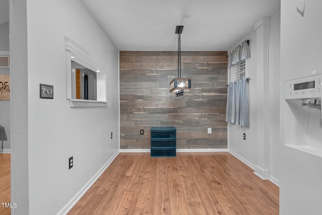 196 Red Wing Dr, Louisburg, NC 27549 - unfurnished dining area with wood walls, wood finished floors, and an accent wall