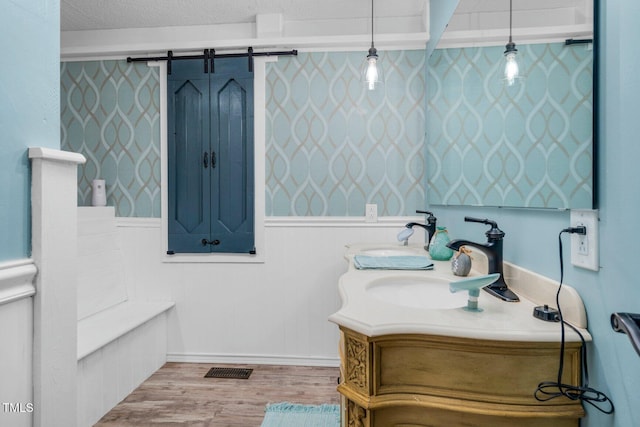 196 Red Wing Dr, Louisburg, NC 27549 - full bathroom featuring double vanity, wood finished floors, and wainscoting