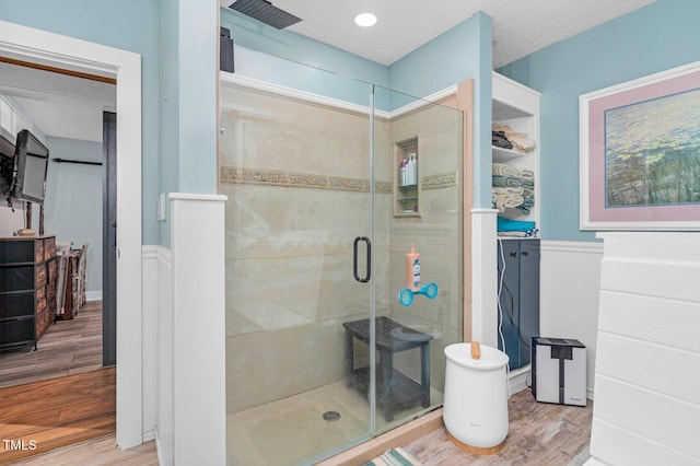 196 Red Wing Dr, Louisburg, NC 27549 - full bathroom featuring a wainscoted wall, a shower stall, and wood finished floors