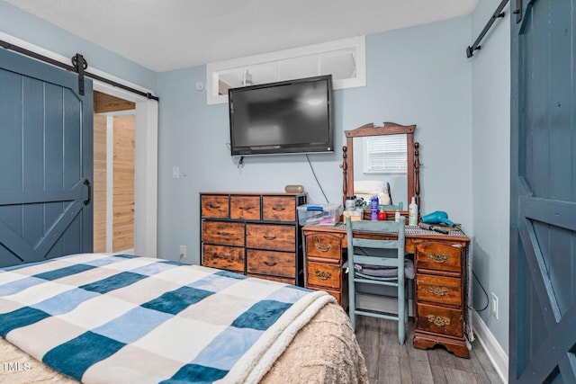 196 Red Wing Dr, Louisburg, NC 27549 - bedroom with a barn door and wood finished floors