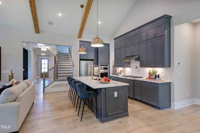 6104 Hope Farm Ln Unit 2, Wake Forest, NC 27587 - kitchen with appliances with stainless steel finishes, under cabinet range hood, light wood-style floors, tasteful backsplash, and recessed lighting