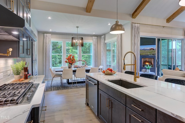 6104 Hope Farm Ln Unit 2, Wake Forest, NC 27587 - kitchen featuring ventilation hood, beamed ceiling, stainless steel appliances, light wood-style flooring, and healthy amount of natural light