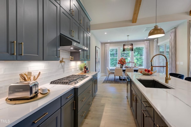 6104 Hope Farm Ln Unit 2, Wake Forest, NC 27587 - kitchen with under cabinet range hood, appliances with stainless steel finishes, light wood-style flooring, tasteful backsplash, and plenty of natural light