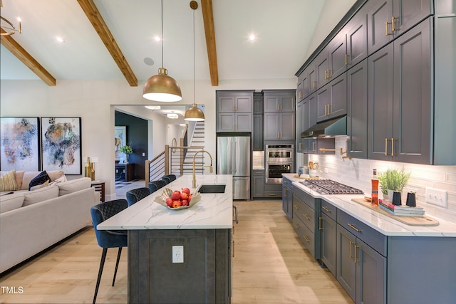 6104 Hope Farm Ln Unit 2, Wake Forest, NC 27587 - kitchen featuring stainless steel appliances, a kitchen breakfast bar, light wood finished floors, open floor plan, and beam ceiling