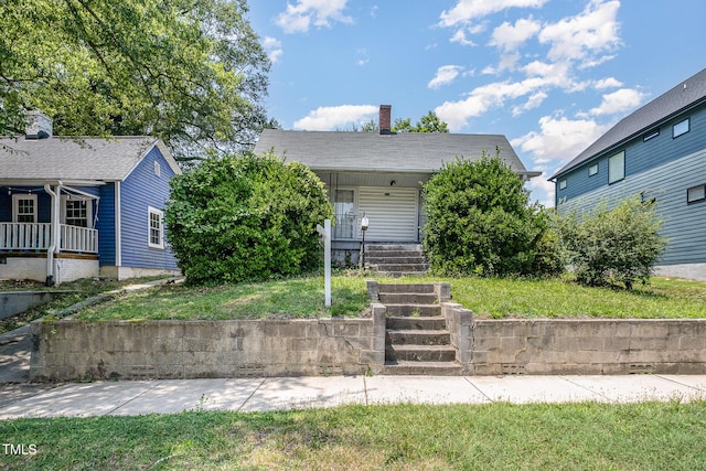 805 N Duke St, Durham, NC 27701 - view of front of property with a porch, a front lawn, and a chimney