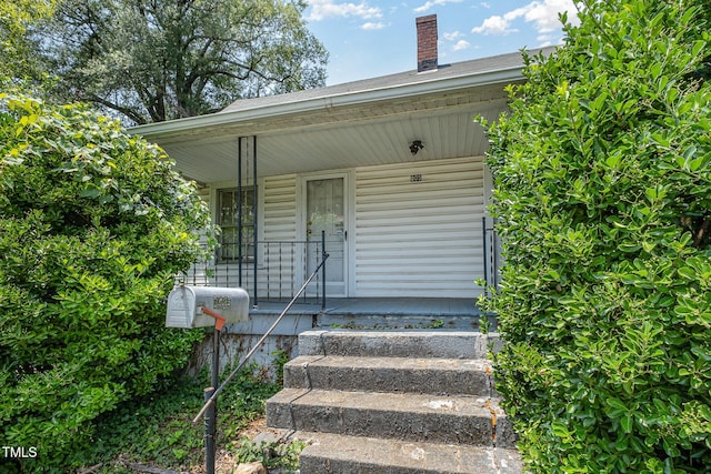 805 N Duke St, Durham, NC 27701 - doorway to property featuring a porch and a chimney