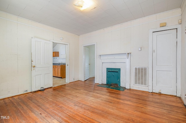 805 N Duke St, Durham, NC 27701 - unfurnished living room featuring light wood-type flooring and a fireplace