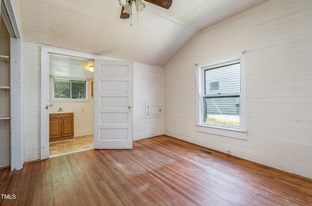 805 N Duke St, Durham, NC 27701 - unfurnished bedroom with vaulted ceiling, hardwood / wood-style floors, connected bathroom, and ceiling fan