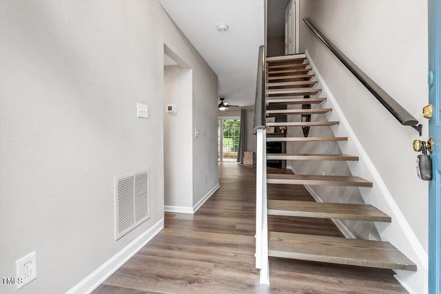 7771 Falcon Rest Cir, Raleigh, NC 27615 - stairway featuring a ceiling fan and wood finished floors