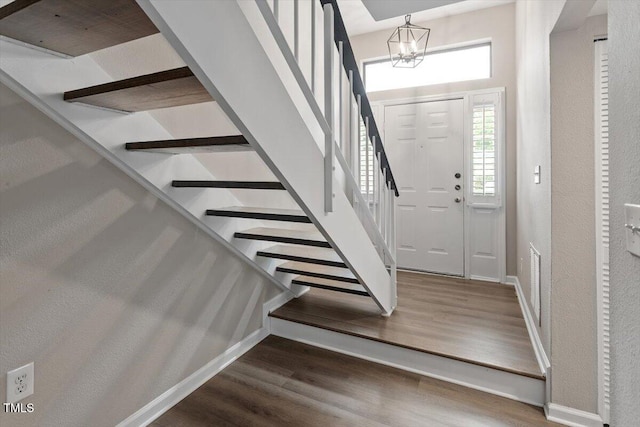 7771 Falcon Rest Cir, Raleigh, NC 27615 - entryway with stairway, plenty of natural light, wood finished floors, and a textured wall