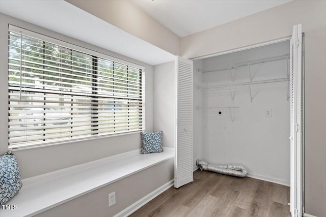 7771 Falcon Rest Cir, Raleigh, NC 27615 - washroom featuring hookup for an electric dryer and wood finished floors