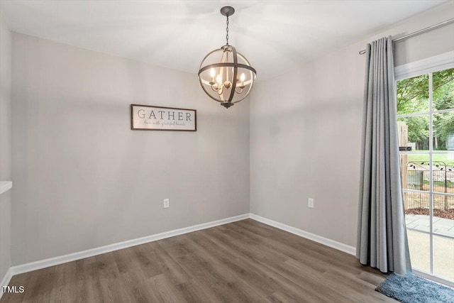 7771 Falcon Rest Cir, Raleigh, NC 27615 - empty room with a chandelier and wood finished floors
