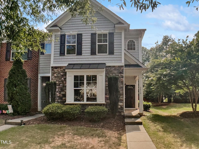 3010 Berkeley Springs Pl, Raleigh, NC 27616 - view of front facade with stone siding and a front yard
