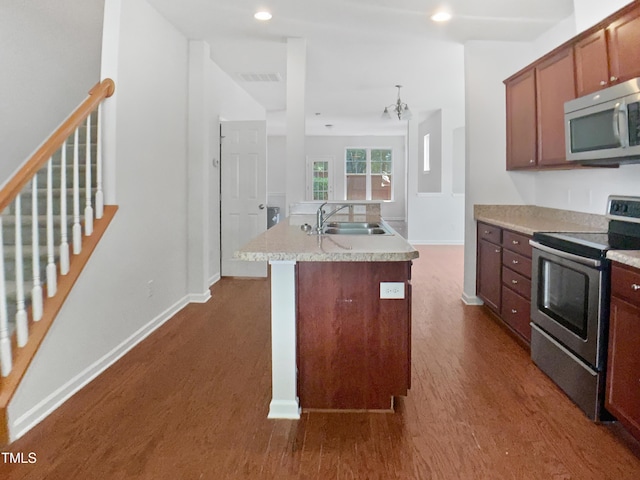 3010 Berkeley Springs Pl, Raleigh, NC 27616 - kitchen with stainless steel appliances, dark wood finished floors, an island with sink, light countertops, and recessed lighting