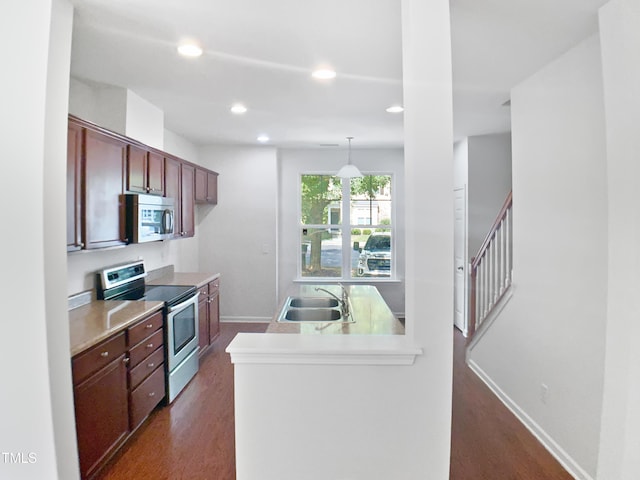3010 Berkeley Springs Pl, Raleigh, NC 27616 - kitchen featuring appliances with stainless steel finishes, dark wood-style floors, light countertops, and recessed lighting