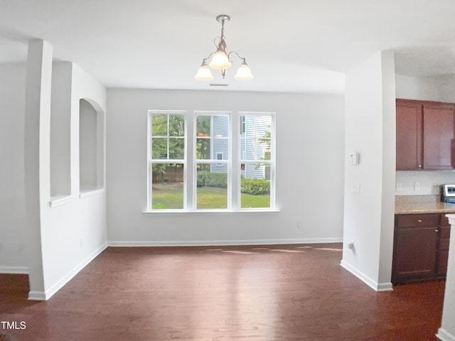3010 Berkeley Springs Pl, Raleigh, NC 27616 - unfurnished dining area with dark wood-type flooring and a chandelier