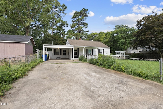 2510 Springhill Ave, Raleigh, NC 27603 - ranch-style house featuring a porch, concrete driveway, a carport, and a chimney
