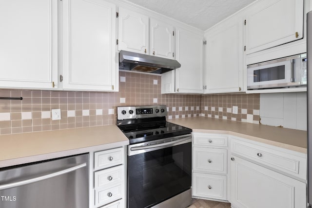 2510 Springhill Ave, Raleigh, NC 27603 - kitchen featuring appliances with stainless steel finishes, under cabinet range hood, light countertops, tasteful backsplash, and a textured ceiling