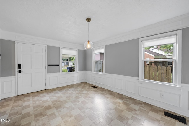 2510 Springhill Ave, Raleigh, NC 27603 - unfurnished dining area featuring a decorative wall and wainscoting