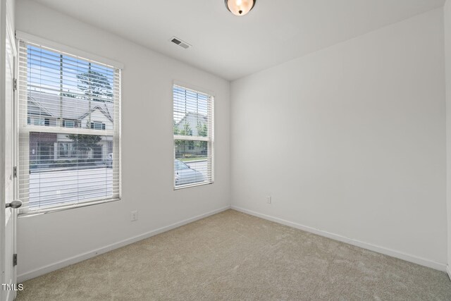120 Holly Berry Ln, Durham, NC 27703 - carpeted empty room with baseboards