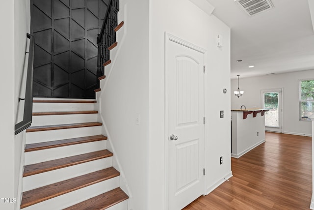 120 Holly Berry Ln, Durham, NC 27703 - stairs with wood finished floors, recessed lighting, and a chandelier