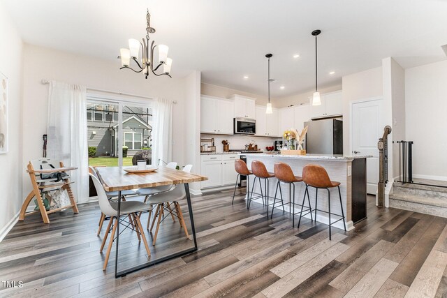 3019 Newfields Pl, Durham, NC 27703 - kitchen featuring appliances with stainless steel finishes, dark wood-style floors, a kitchen island, white cabinetry, and recessed lighting
