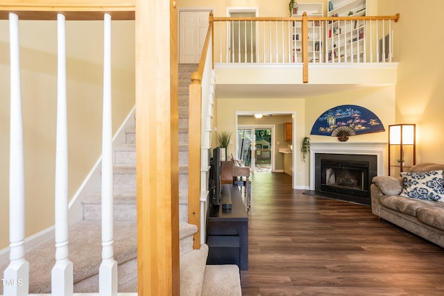 10 Biltmore Pl, Durham, NC 27712 - living area with wood finished floors, stairway, a fireplace with flush hearth, and a high ceiling