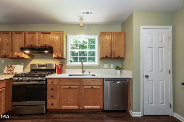 10 Biltmore Pl, Durham, NC 27712 - kitchen with stainless steel appliances, under cabinet range hood, light countertops, and dark wood finished floors