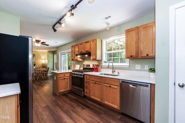 10 Biltmore Pl, Durham, NC 27712 - kitchen with stainless steel appliances, a peninsula, dark wood-style flooring, under cabinet range hood, and light countertops