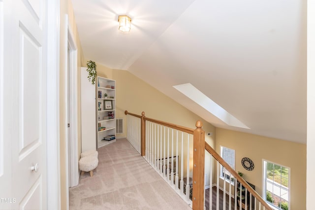 10 Biltmore Pl, Durham, NC 27712 - hallway with a skylight, vaulted ceiling, light colored carpet, and an upstairs landing