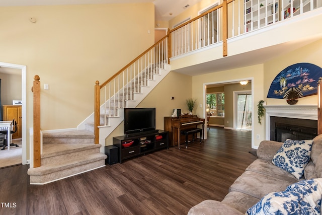 10 Biltmore Pl, Durham, NC 27712 - living room with wood finished floors, stairs, a towering ceiling, and a fireplace