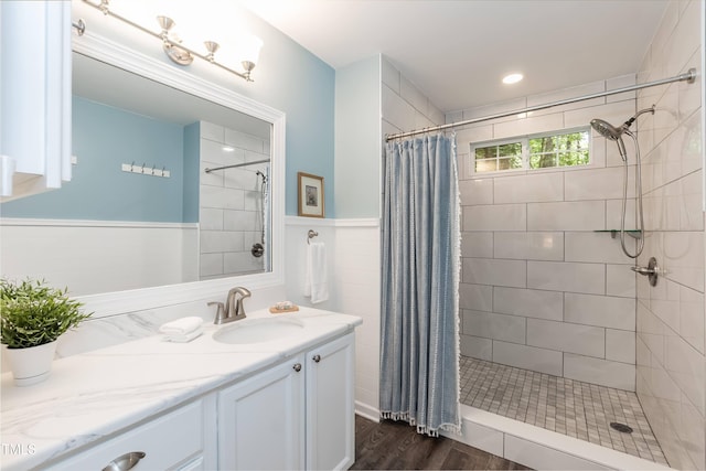 10 Biltmore Pl, Durham, NC 27712 - bathroom with vanity, wood finished floors, tiled shower, and a wainscoted wall